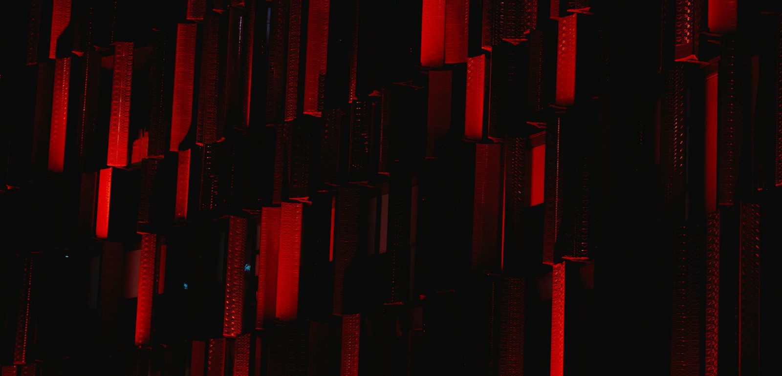 a dark room with a red light coming from the ceiling