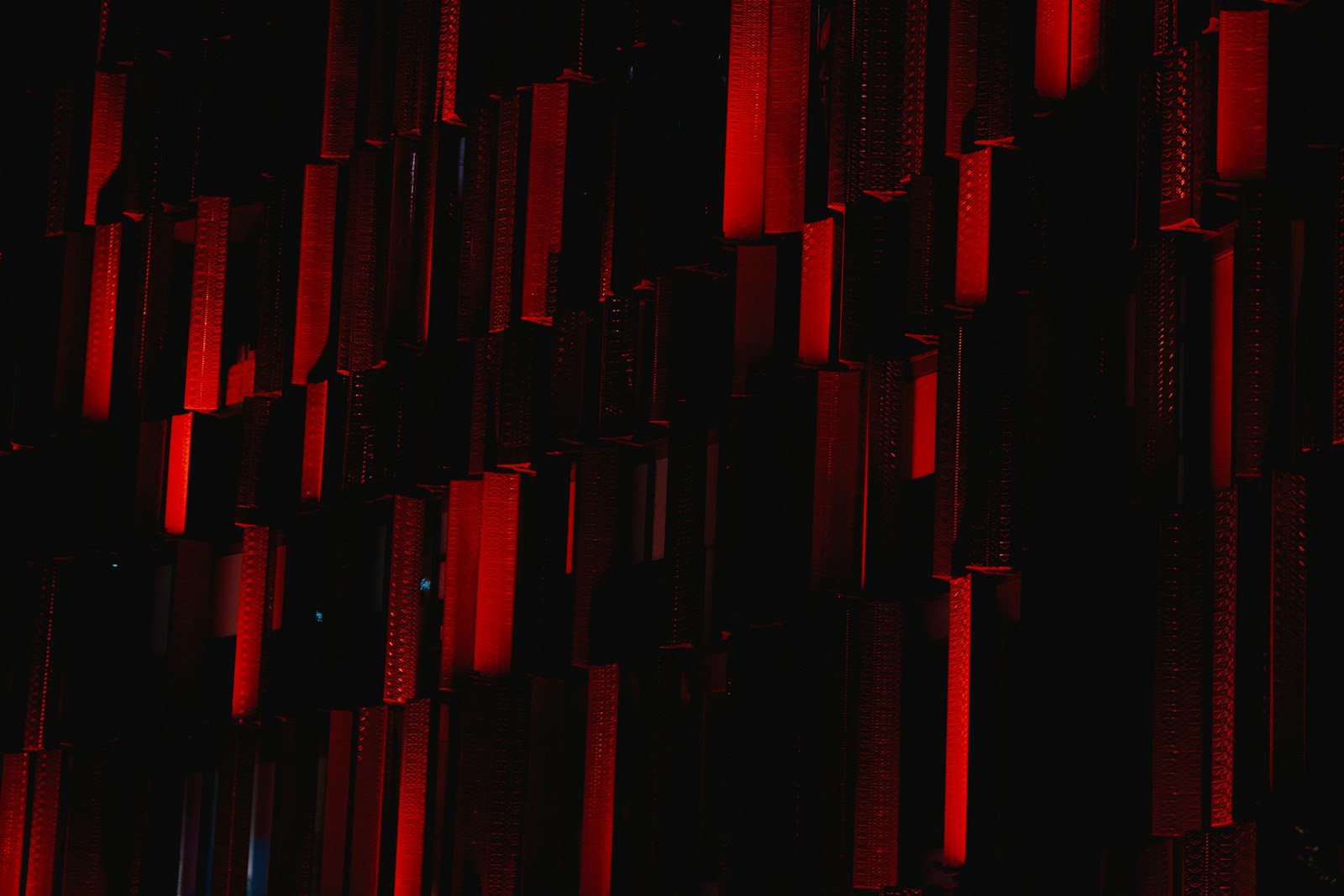 a dark room with a red light coming from the ceiling